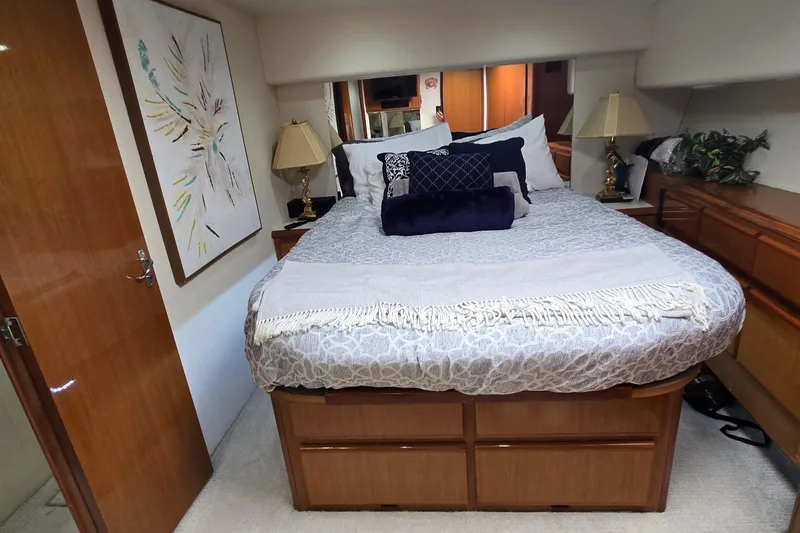Covert Mission Yacht Photos Pics Luxurious master stateroom with elegant bedding and decor. Storage under bed,