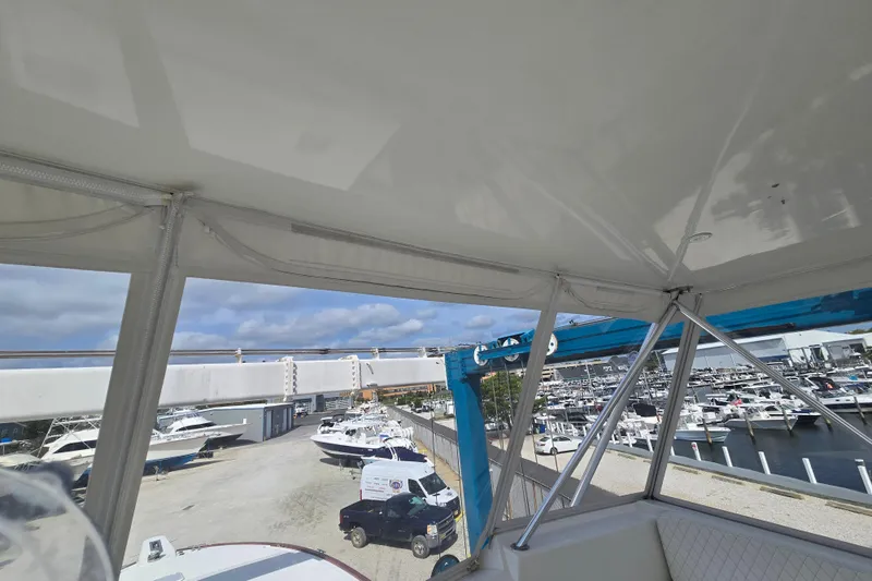 Covert Mission Yacht Photos Pics 1998 Viking 58 Convertible yacht at marina, view from interior with boats and blue sky.