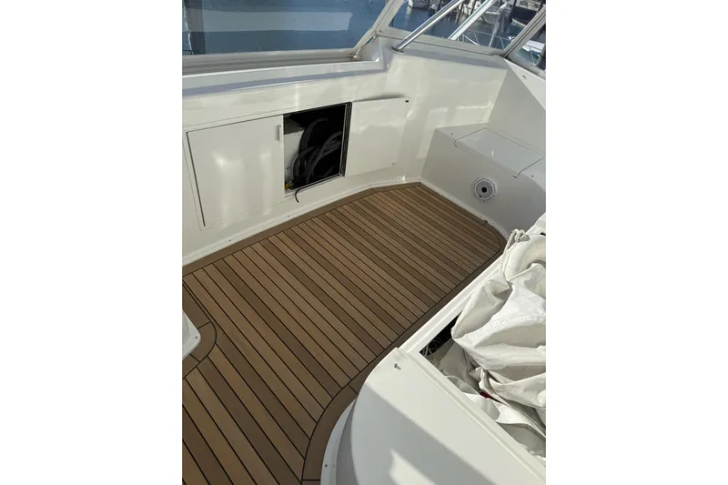 Covert Mission Yacht Photos Pics 1998 Viking 58 Convertible boat deck with wood flooring and storage compartments.
