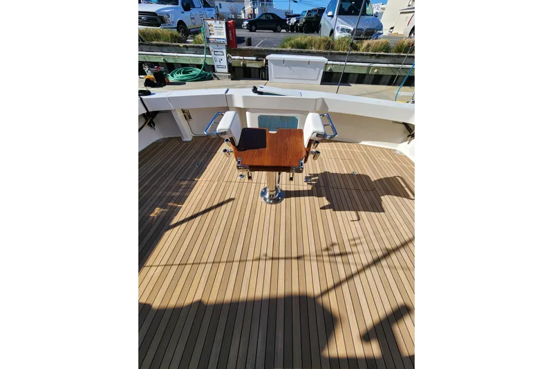 Covert Mission Yacht Photos Pics 1998 Viking 58 Convertible yacht deck with fishing chair and teak flooring.