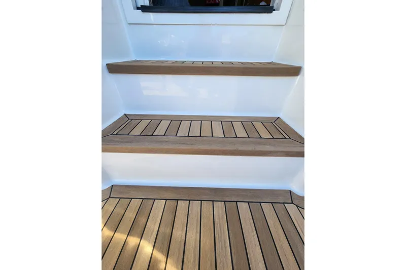 Covert Mission Yacht Photos Pics Teak steps on 1998 Viking 58 Convertible yacht, showcasing elegant marine craftsmanship.