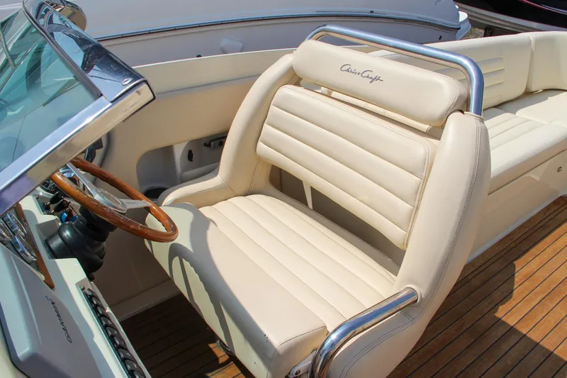 Wahoo Yacht Photos Pics 2013 Chris-Craft Launch 28 boat interior with cream leather seats and wooden steering wheel.