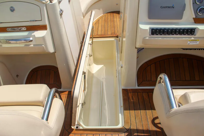 Wahoo Yacht Photos Pics 2013 Chris-Craft Launch 28 interior with open storage compartment and teak flooring.