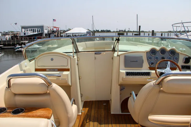Wahoo Yacht Photos Pics 2013 Chris-Craft Launch 28 boat interior with beige leather seats and wooden dashboard.