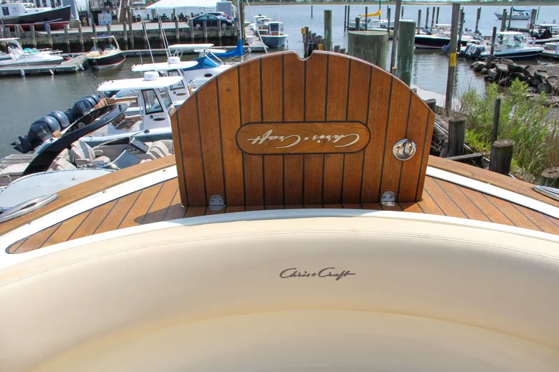 Wahoo Yacht Photos Pics 2013 Chris-Craft Launch 28 boat with wooden deck and branded seating at a marina.