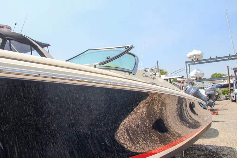 Wahoo Yacht Photos Pics 2013 Chris-Craft Launch 28 boat docked, side view with sleek design and open cockpit.