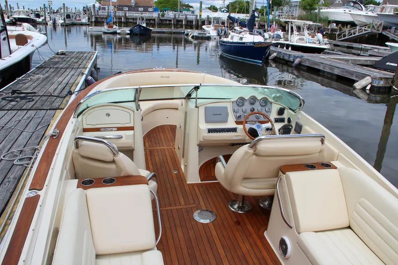 Wahoo Yacht Photos Pics 2013 Chris-Craft Launch 28 boat interior at a marina, featuring luxurious seating and wooden deck.