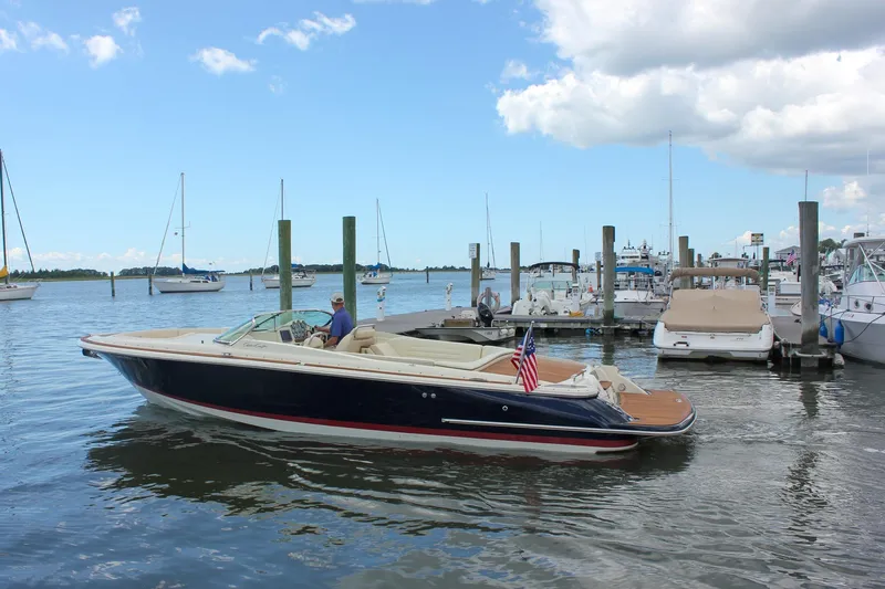 Wahoo Yacht Photos Pics 2013 Chris-Craft Launch 28 boat docked at a marina, surrounded by sailboats.