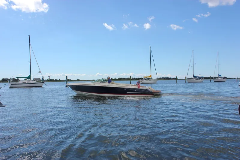 Wahoo Yacht Photos Pics 2013 Chris-Craft Launch 28 boat cruising on a sunny day with sailboats in the background.