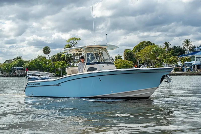 Little P Yacht Photos Pics 2016 Grady-White Canyon 271 FS boat on calm water, under cloudy sky.