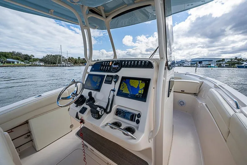 Little P Yacht Photos Pics 2016 Grady-White Canyon 271 FS boat cockpit with navigation screens and steering wheel.