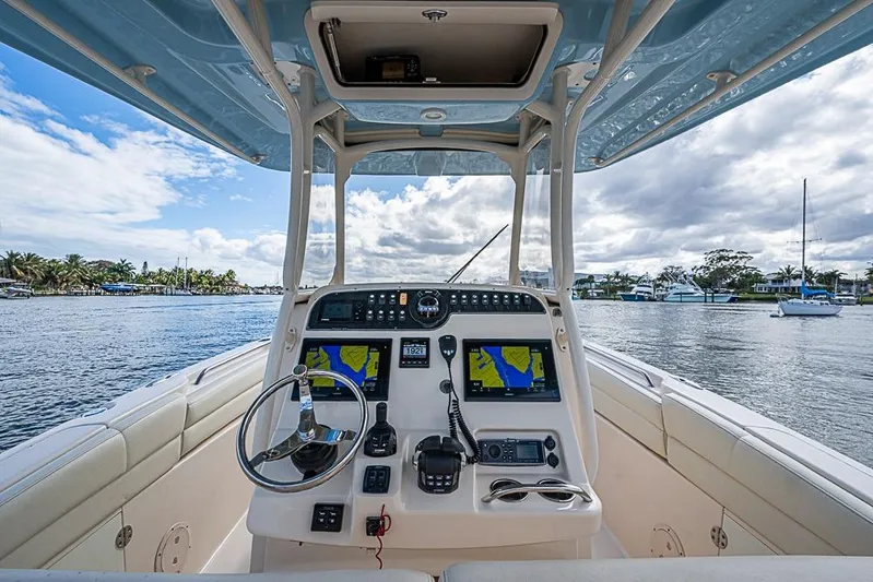 Little P Yacht Photos Pics 2016 Grady-White Canyon 271 FS boat helm with navigation screens on a sunny day.