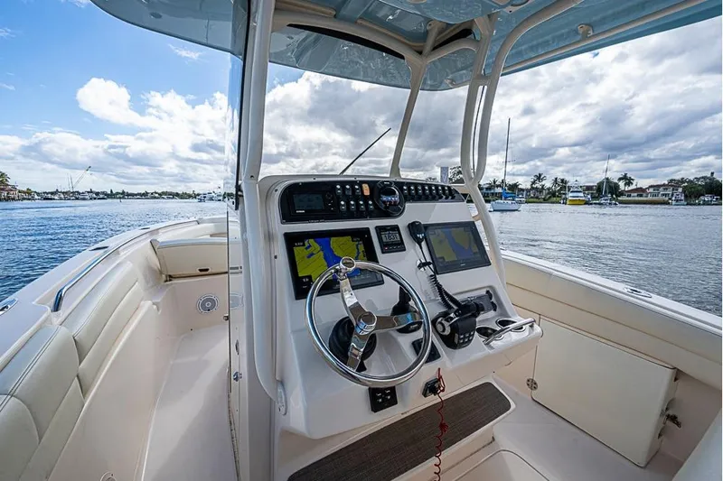 Little P Yacht Photos Pics 2016 Grady-White Canyon 271 FS boat helm with navigation screens on a sunny day.
