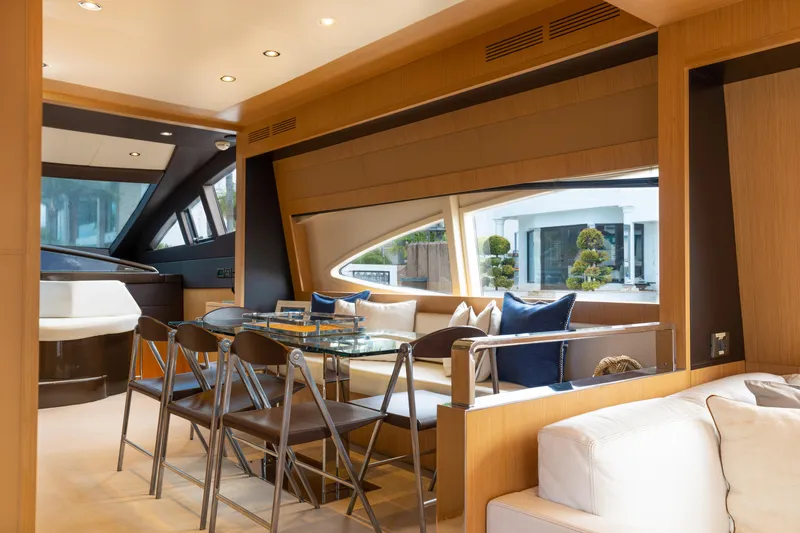  Yacht Photos Pics Luxurious interior of 2012 Riva 75 Venere yacht with modern dining area and large windows.