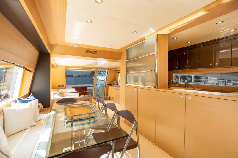  Yacht Photos Pics Luxurious interior of 2012 Riva 75 Venere yacht with modern dining area and kitchen.