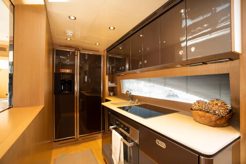  Yacht Photos Pics Modern kitchen interior of 2012 Riva 75 Venere yacht with sleek cabinets and appliances.