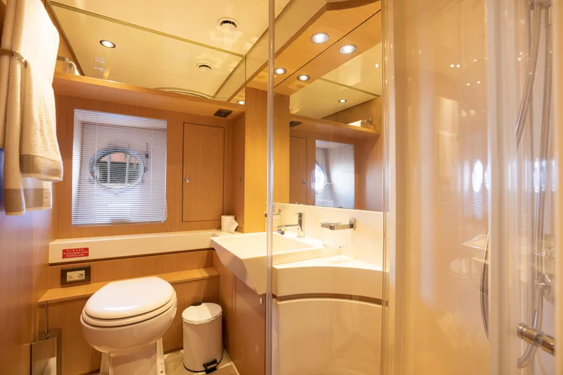  Yacht Photos Pics Luxurious bathroom on a 2012 Riva 75 Venere yacht with modern fixtures and wooden accents.