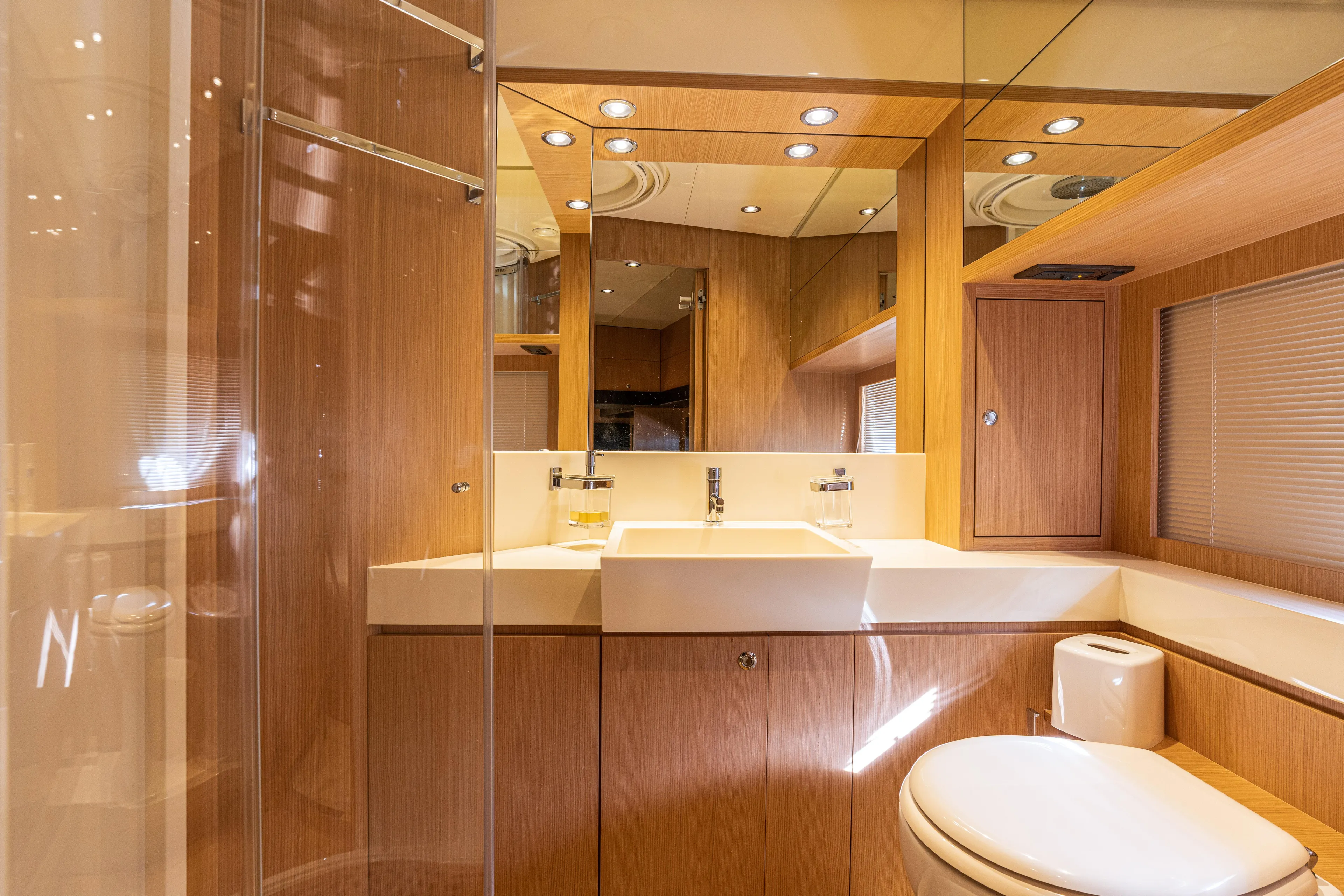  Yacht Photos Pics Luxurious bathroom interior of 2012 Riva 75 Venere yacht with modern fixtures and wooden finishes.