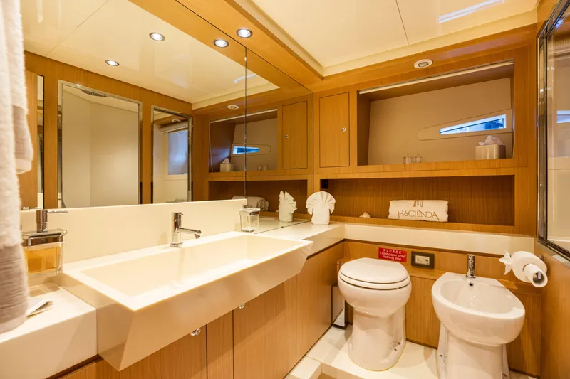  Yacht Photos Pics Luxurious bathroom in 2012 Riva 75 Venere yacht with modern fixtures and wooden cabinetry.