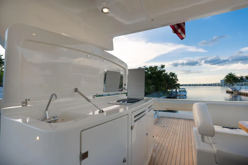  Yacht Photos Pics Outdoor kitchen on a 2012 Riva 75 Venere yacht with scenic waterfront view.