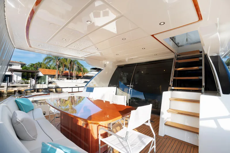  Yacht Photos Pics Luxurious 2012 Riva 75 Venere yacht deck with elegant seating and dining area.