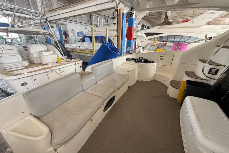  Yacht Photos Pics 2006 Azimut 55E yacht interior with seating and stairs in a marina setting.