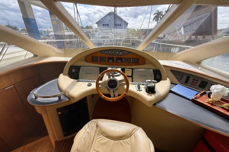  Yacht Photos Pics 2006 Azimut 55E yacht helm with Garmin navigation, luxurious interior, and panoramic windows.