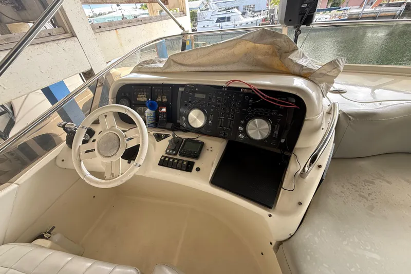  Yacht Photos Pics 2006 Azimut 55E yacht helm with steering wheel and control panel, docked at marina.