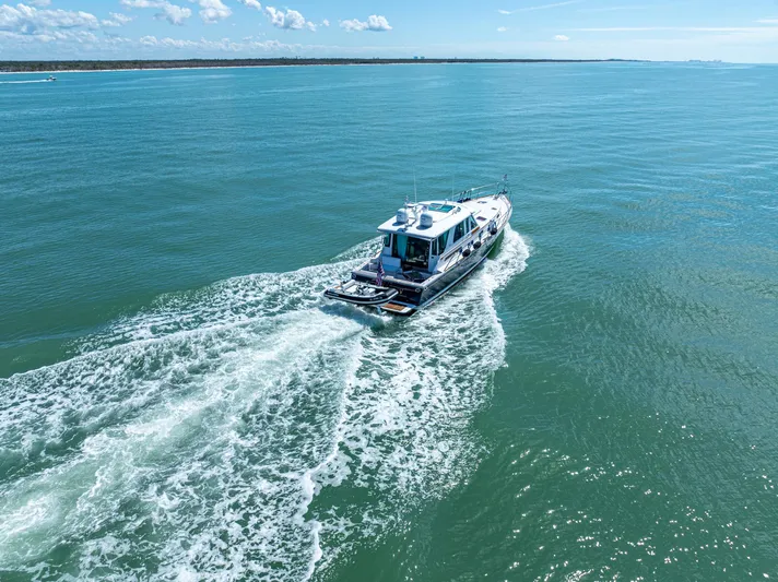  Yacht Photos Pics 2009 Sabre 52 Express yacht cruising on open blue waters.