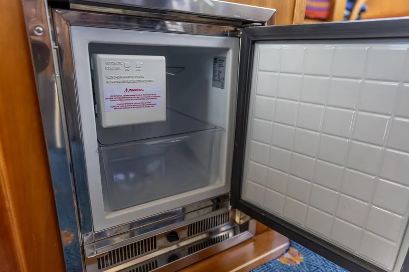  Yacht Photos Pics Open refrigerator inside 2009 Sabre 52 Express yacht, showcasing interior storage space.