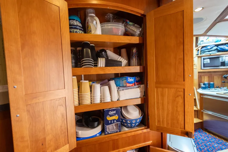  Yacht Photos Pics Wooden cabinet stocked with disposable cups and plates inside a 2009 Sabre 52 Express yacht.