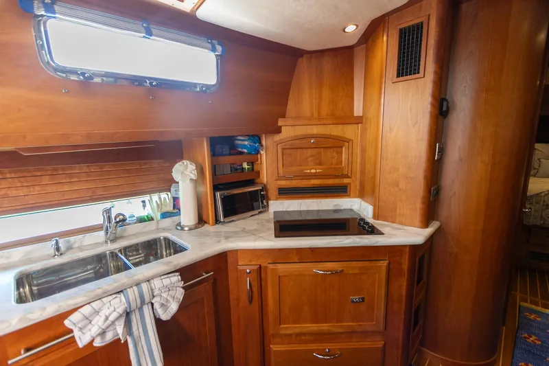  Yacht Photos Pics Luxurious wooden kitchen interior of 2009 Sabre 52 Express yacht with modern amenities.