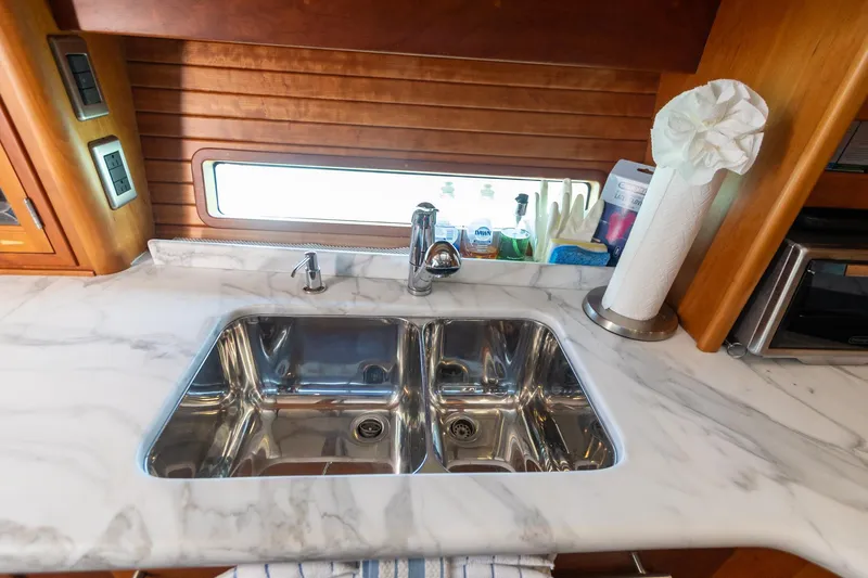  Yacht Photos Pics 2009 Sabre 52 Express yacht kitchen with marble countertop and double sink.