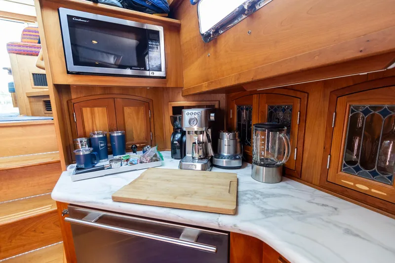  Yacht Photos Pics 2009 Sabre 52 Express yacht kitchen with appliances and wooden cabinetry.