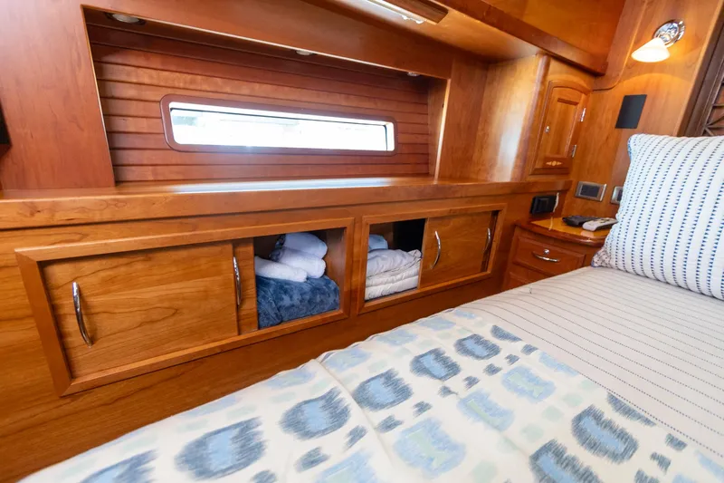  Yacht Photos Pics Luxurious wooden interior of 2009 Sabre 52 Express yacht cabin with storage and bedding.