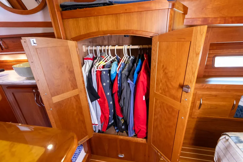  Yacht Photos Pics Wooden wardrobe with hanging clothes inside a 2009 Sabre 52 Express yacht interior.