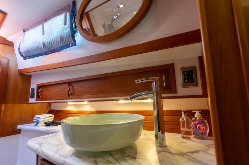  Yacht Photos Pics Luxurious bathroom in 2009 Sabre 52 Express yacht with modern sink and elegant wood accents.