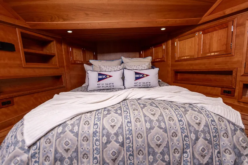 Yacht Photos Pics Luxurious cabin interior of 2009 Sabre 52 Express yacht with elegant bedding and wood finish.