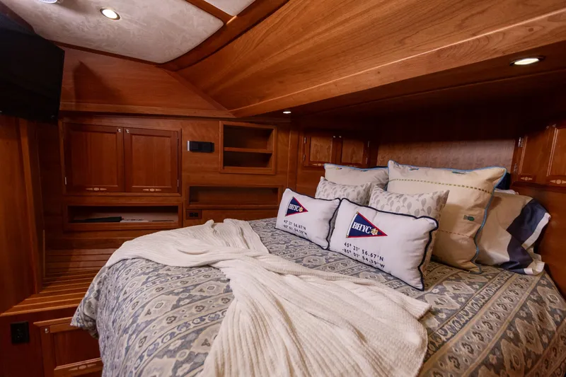  Yacht Photos Pics Luxurious 2009 Sabre 52 Express yacht cabin with cozy bedding and elegant wood finish.