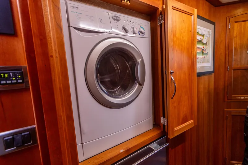  Yacht Photos Pics Washer in wooden cabinet on 2009 Sabre 52 Express yacht interior.