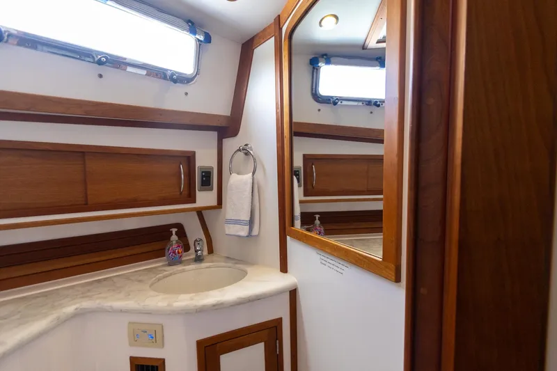  Yacht Photos Pics 2009 Sabre 52 Express yacht bathroom with wooden accents and marble countertop.