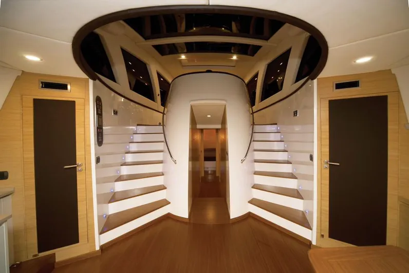 Ea Yacht Photos Pics Luxurious interior of 2010 Custom Wake 66 yacht with elegant wooden flooring and modern staircase design.