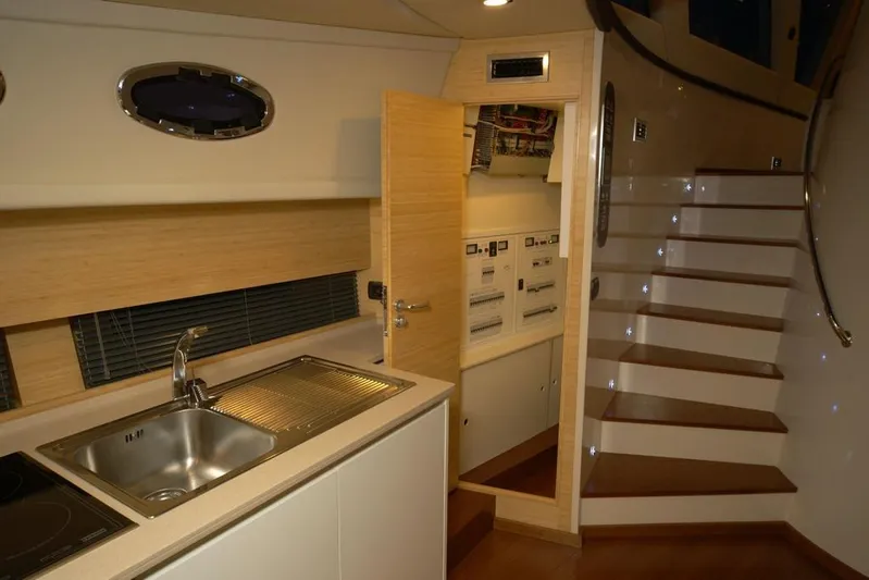 Ea Yacht Photos Pics Modern yacht interior with kitchenette, stairs, and control panel, Custom Wake 66, 2010 model.