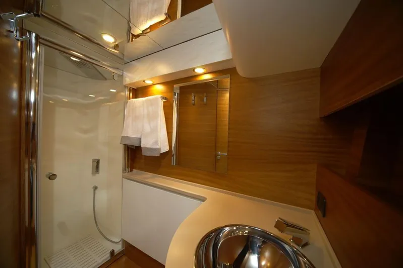 Ea Yacht Photos Pics Luxurious bathroom in 2010 Custom Wake 66 yacht with modern fixtures and wooden accents.