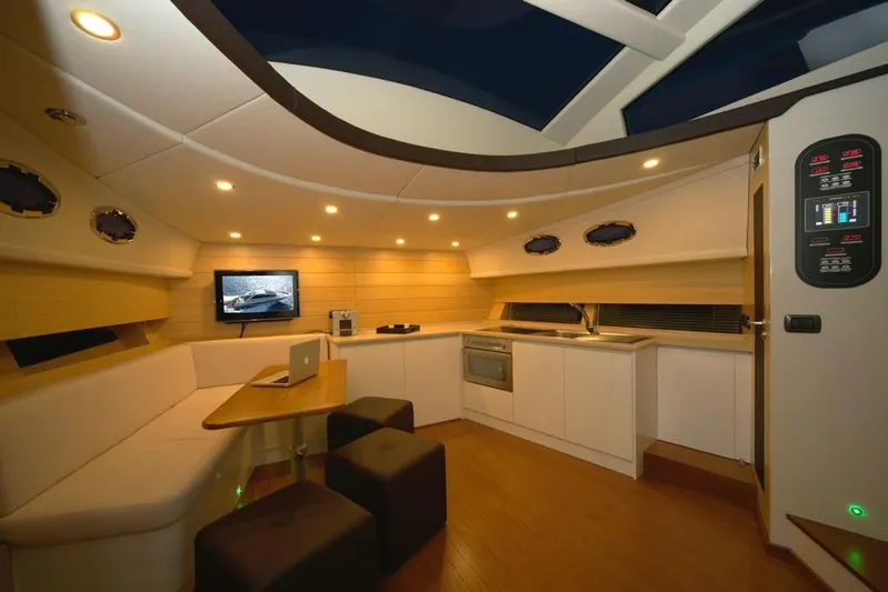 Ea Yacht Photos Pics Luxurious interior of 2010 Custom Wake 66 yacht with modern kitchen and seating area.