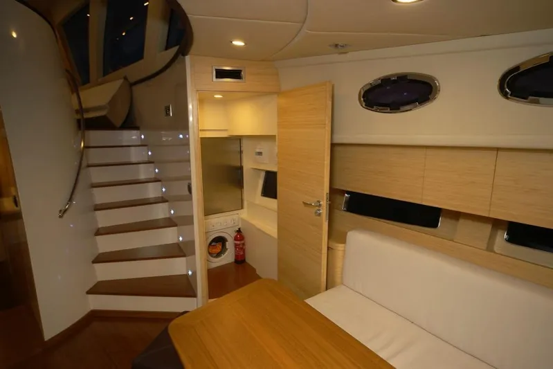 Ea Yacht Photos Pics Luxurious interior of 2010 Custom Wake 66 yacht with modern furnishings and staircase.