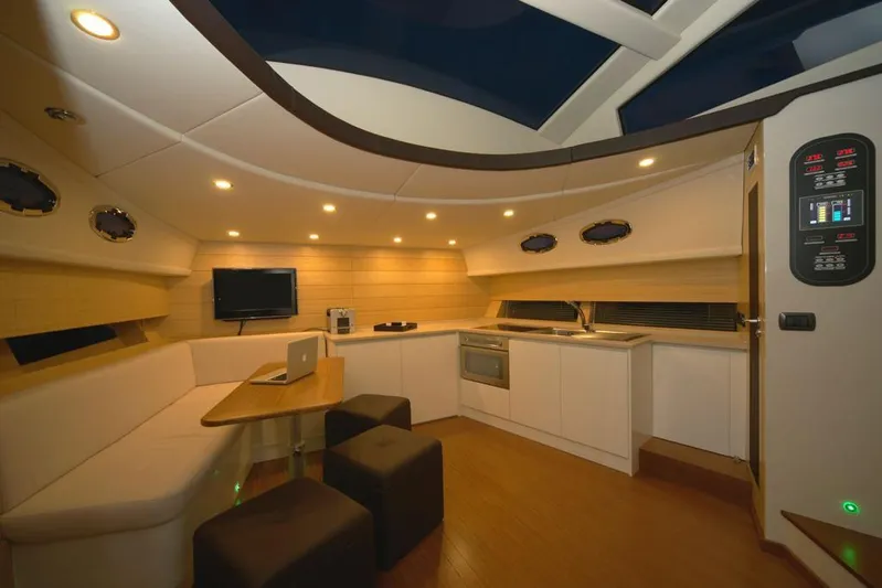Ea Yacht Photos Pics Luxurious interior of 2010 Custom Wake 66 yacht with modern kitchen and seating area.
