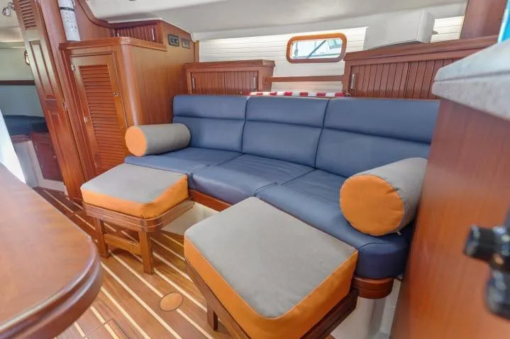 Resolute Yacht Photos Pics Luxurious Blue Jacket 40 yacht interior with blue and orange seating, wooden accents, 2015 model.