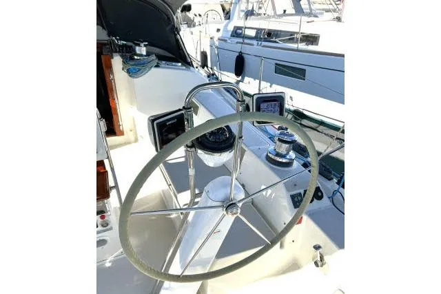 Resolute Yacht Photos Pics Steering wheel of a 2015 Blue Jacket 40 sailboat, docked in a marina.
