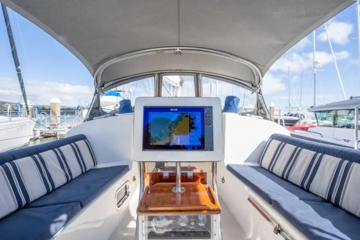 Resolute Yacht Photos Pics Luxurious 2015 Blue Jacket 40 yacht interior with navigation screen and striped seating.